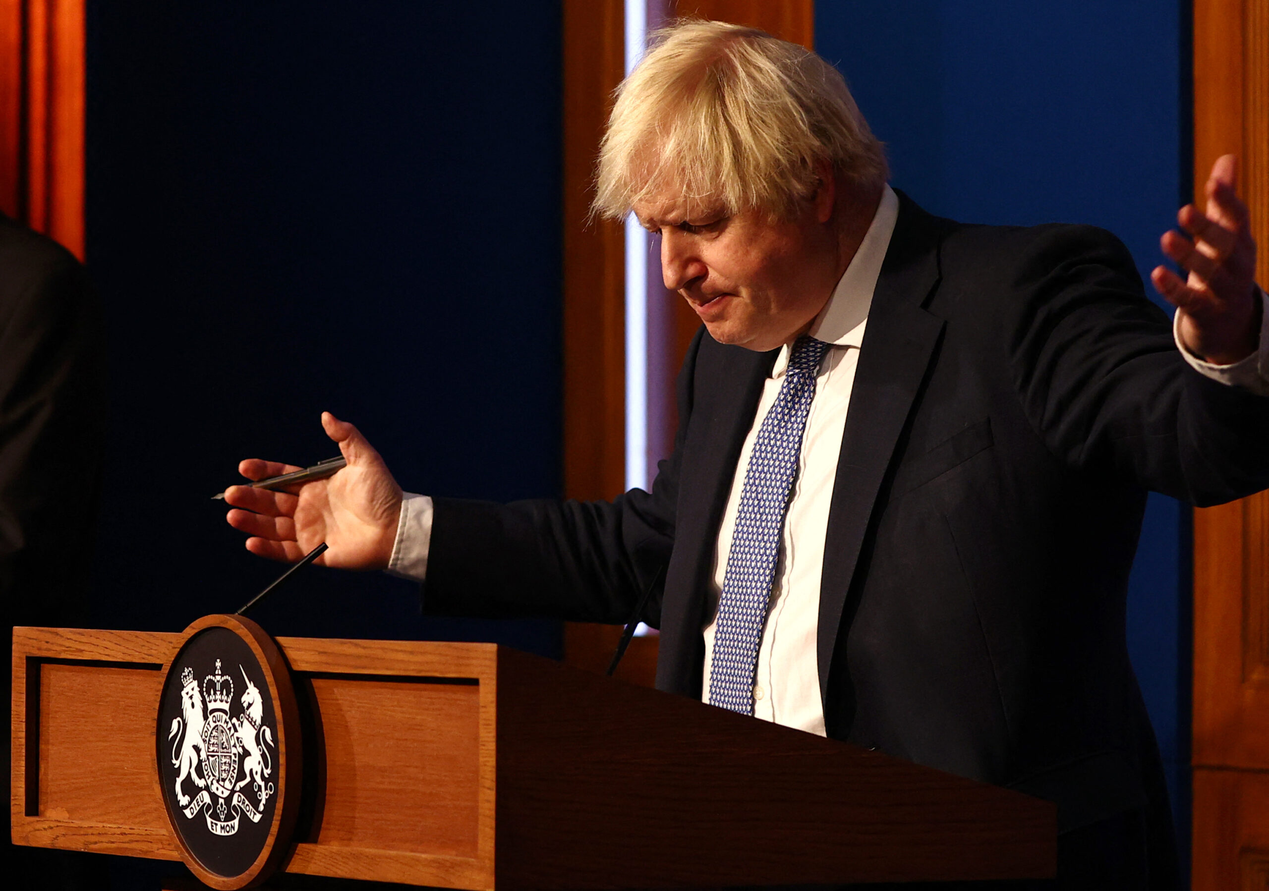 Britain's Prime Minister Boris Johnson gestures during a press conference for the latest Covid-19 update in the Downing Street briefing room in central London on December 8, 2021. - The UK government is reintroducing Covid-19 restrictions due to the Omicron variant. (Photo by Adrian DENNIS / POOL / AFP)