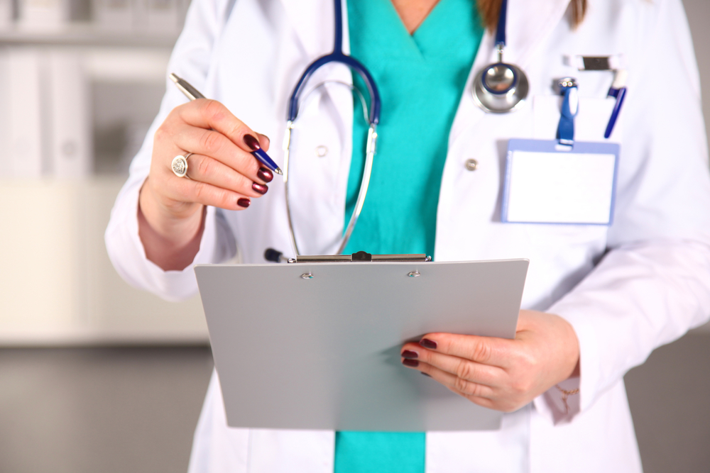 Portrait of happy medical doctor woman in office.