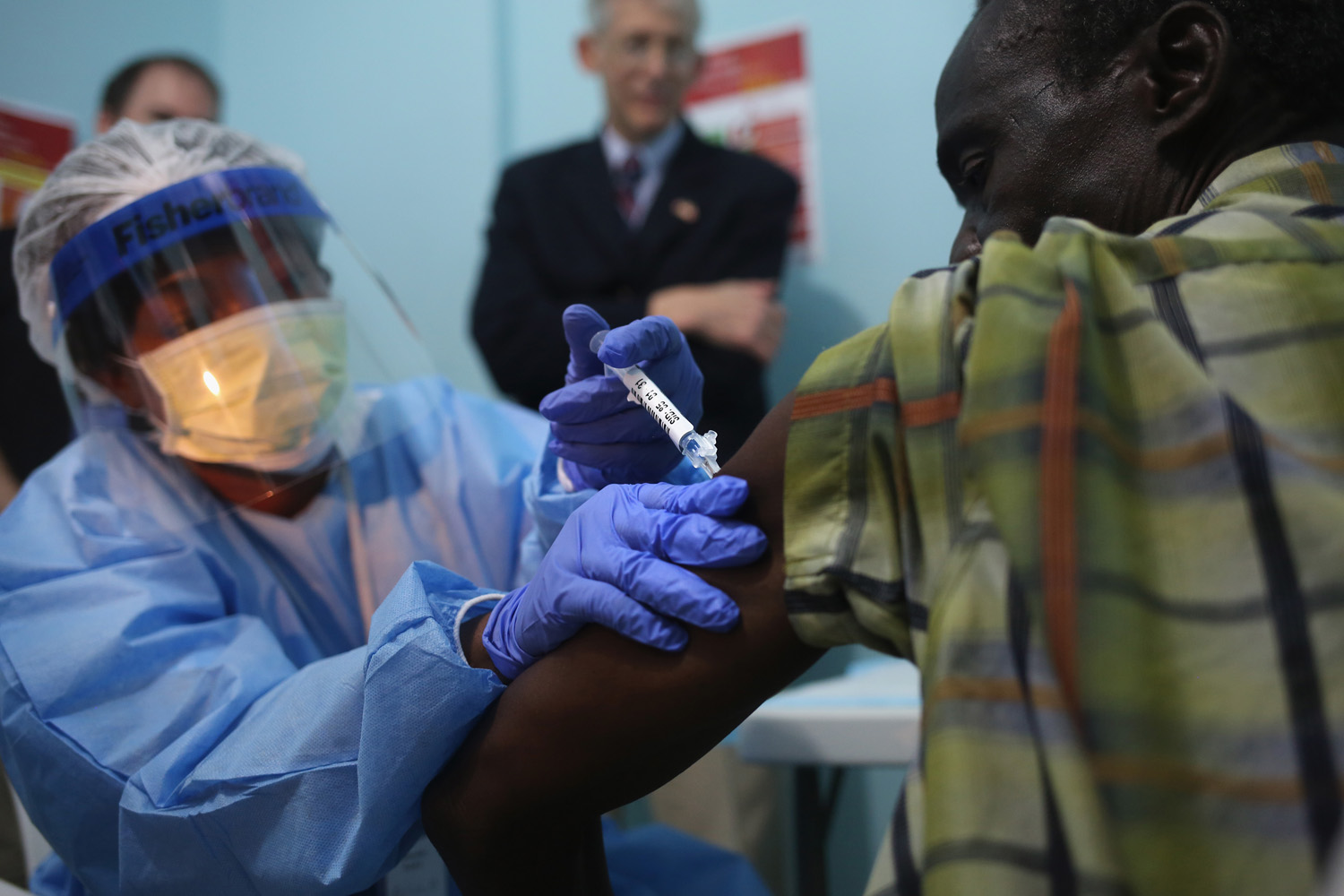 MONROVIA, LIBERIA - FEBRUARY 02:  A nurse administers an injection on the first day of the Ebola vaccine study being conducted at Redemption Hospital, formerly an Ebola holding center, on February 2, 2015 in Monrovia, Liberia. Twelve people were given injections Monday, out of a planned 27,000 people in the Monrovia area. The clinical research study is being conducted jointly by the U.S. National Institutes of Health (NIH), and the Liberian Ministry of Health. The Ebola epidemic virus has killed at least 3,700 people in Liberia alone, the most of any country, and nearly 9,000 across in West Africa.  (Photo by John Moore/Getty Images)