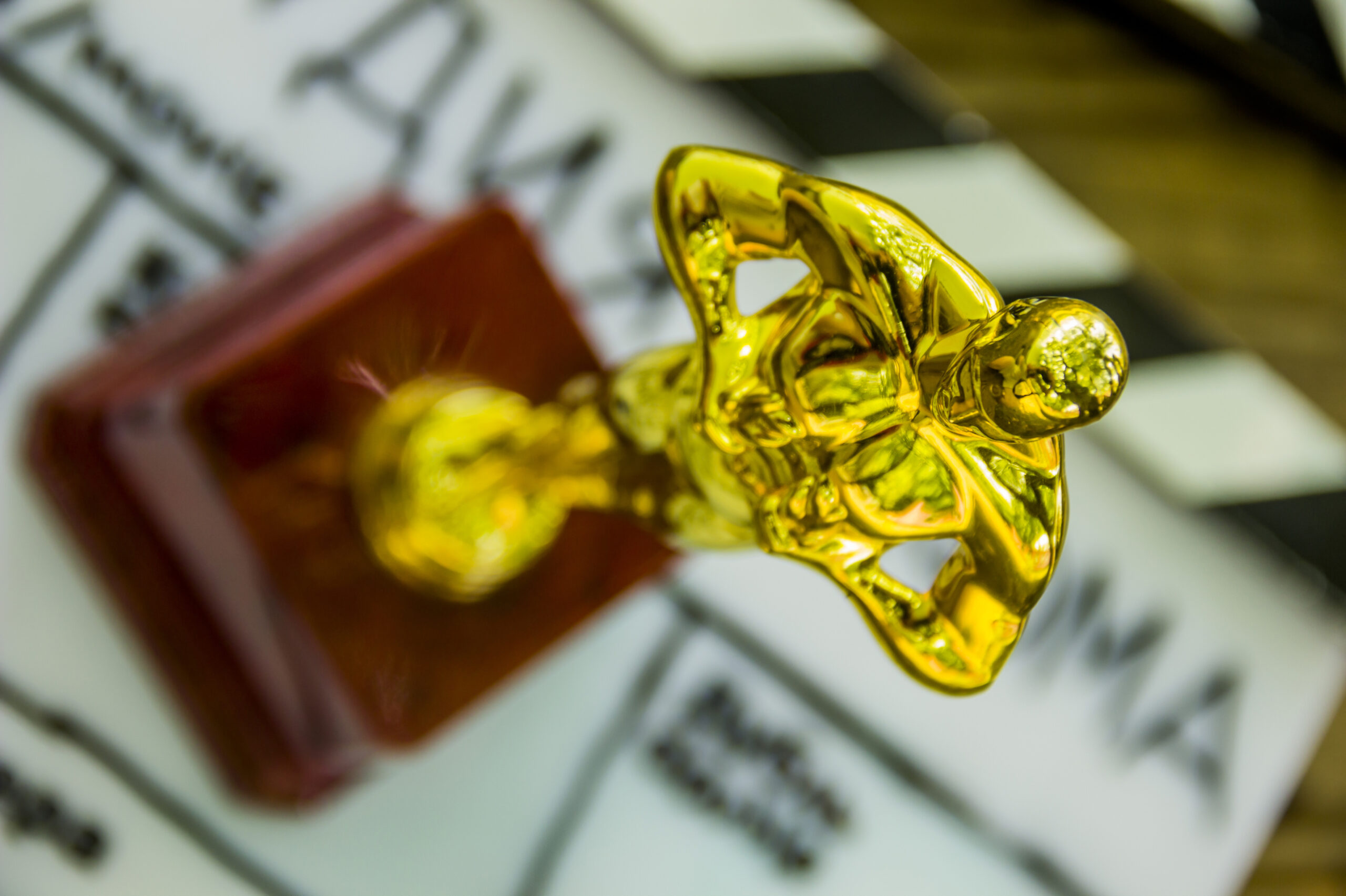 close-up of a decorative oscar figure on blurry film clapper