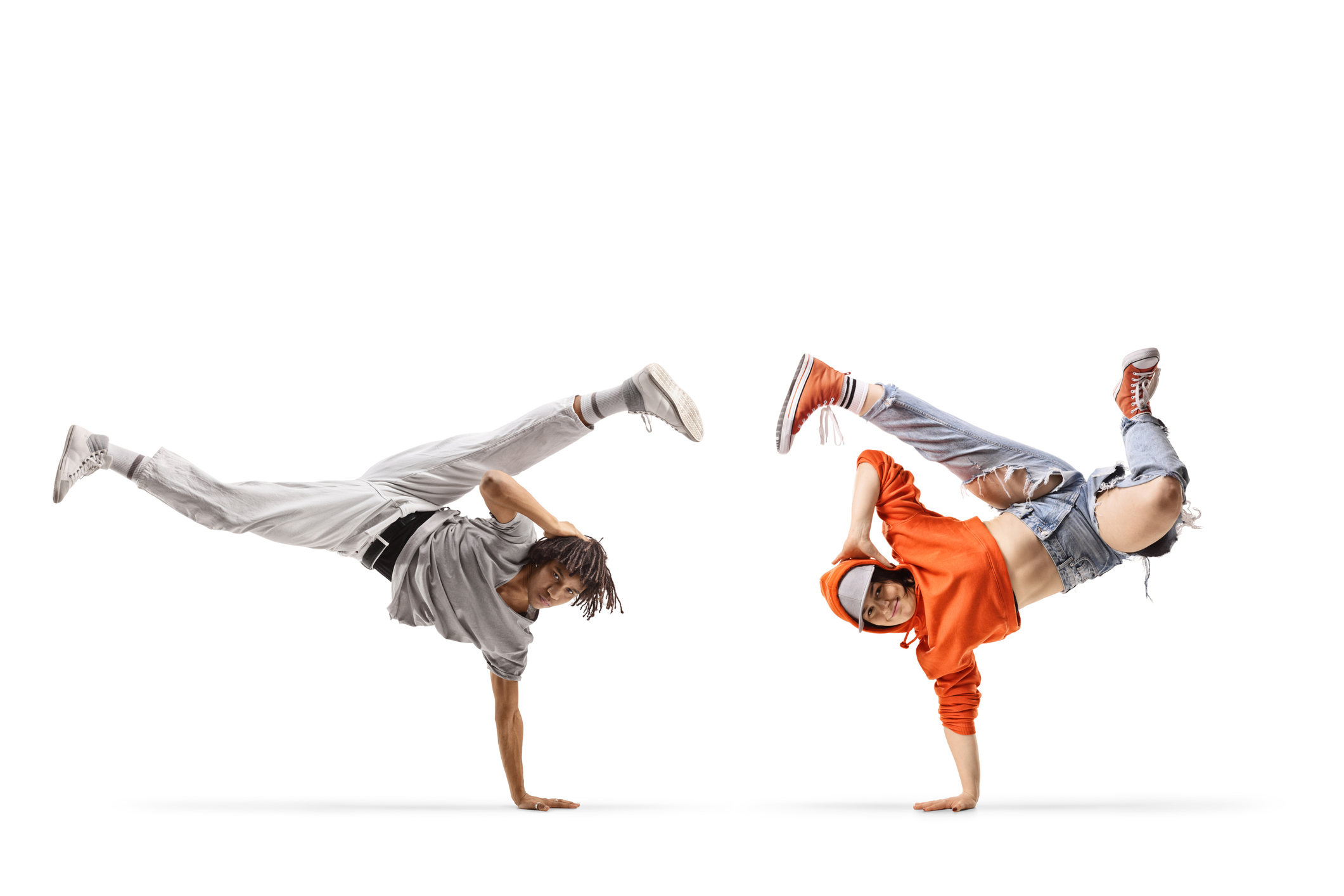 Caucasian female and an african american male performing a handstand isolated on white background