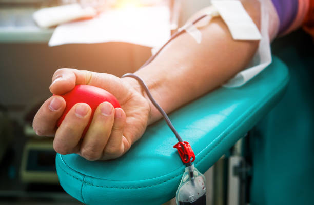 Blood donor at donation with bouncy ball holding in hand