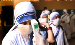Thermal screening of Nuns from the Missionaries of Charity  standing in a queue outside a polling station to cast their ballot during the final phase of West Bengal's state legislative assembly elections in Kolkata on April 29, 2021. (Photo by Dipa Chakraborty/Pacific Press/Sipa USA)No Use Germany.