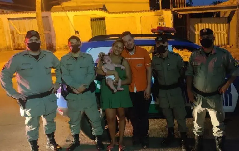 Um dos policiais tomou a criança em seus braços e aplicou a manobra de "Heimlich", que induz a tosse para desobstrução das vias aéreas, o que salvou a vida do bebê | Foto: Divulgação/ 8° BPM de Aparecida