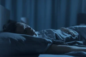 Woman sleeping in her bed at night, healthy lifestyle concept