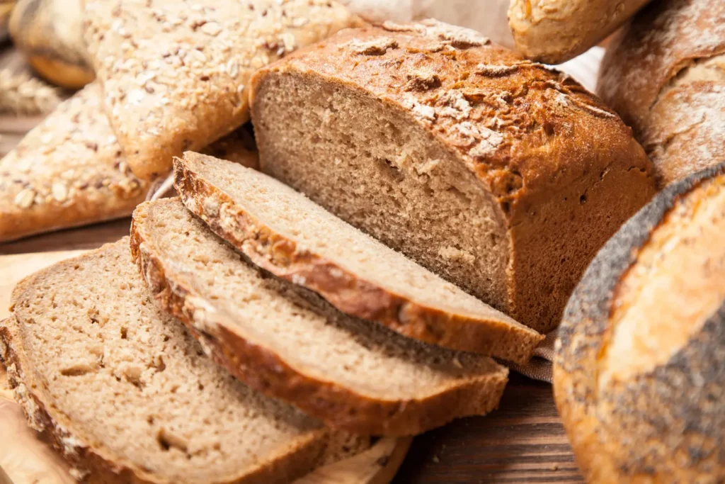Freshly baked bread assortment on wooden surface