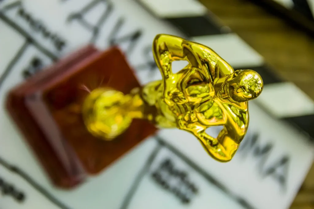 close-up of a decorative oscar figure on blurry film clapper
