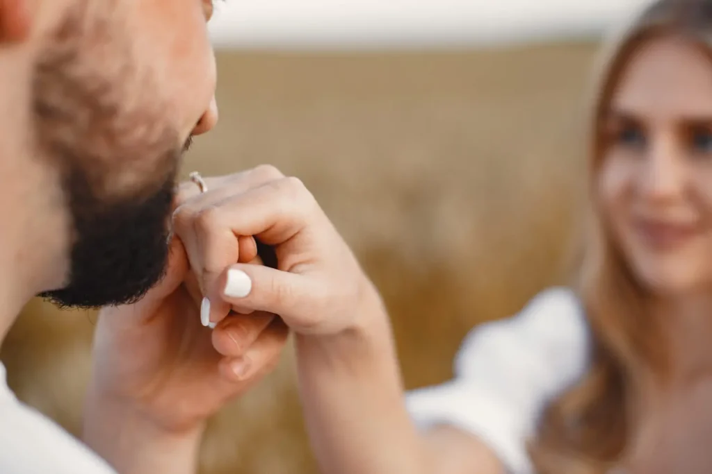 Cute couple in a field. Lady in a white blouse. Guy in a white shirt