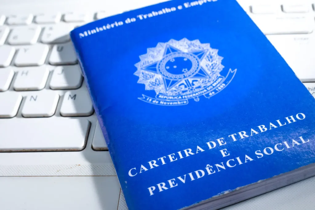 Composition with the employment registration card of Brazil on the keyboard of a Laptop.
