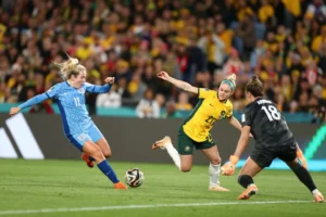 SYDNEY, AUSTRALIA - AUGUST 16: Lauren Hemp of England scores her team's second goal under pressure from Ellie Carpenter of Australia during the FIFA Women's World Cup Australia & New Zealand 2023 Semi Final match between Australia and England at Stadium Australia on August 16, 2023 in Sydney, Australia. (Photo by Naomi Baker - The FA/The FA via Getty Images)