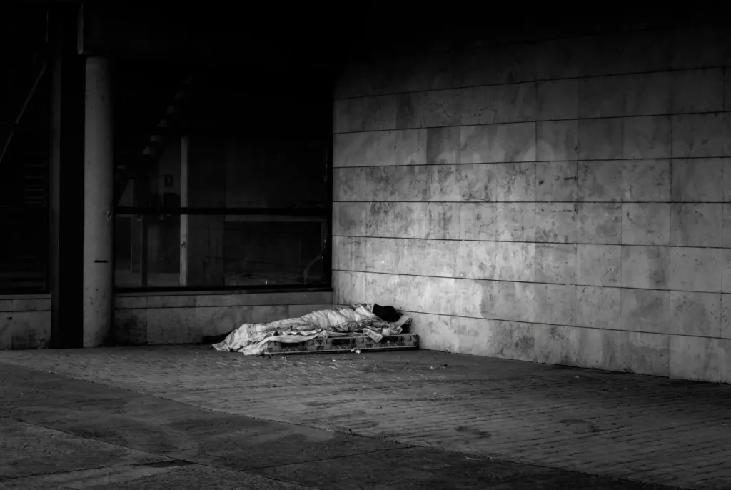 Person sleeping on the street, homeless vagrant, social poverty