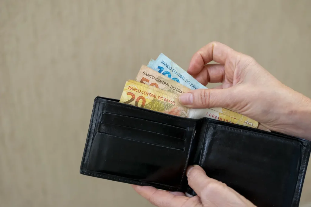 Brazil money. taking Brazilian banknotes from the wallet