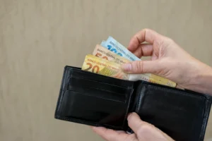 Brazil money. taking Brazilian banknotes from the wallet