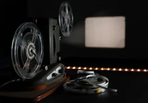 Vintage 8mm film projector with blank frame and reels.