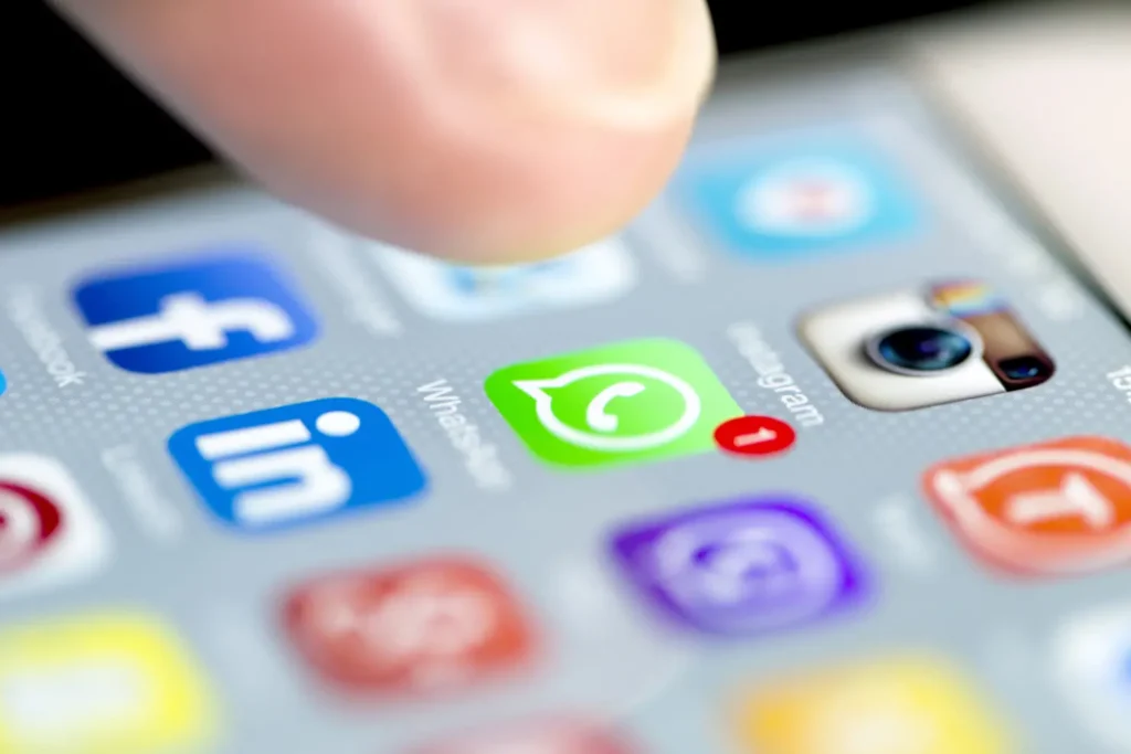 Istanbul, Turkey - September 18, 2015: Apple Iphone 6 screen with social media applications of Whatsapp, Facebook, Instagram, Viber, Linkedin, Tango, Perisfind and Snapchat while a male finger is about to touch on Whatsapp app.