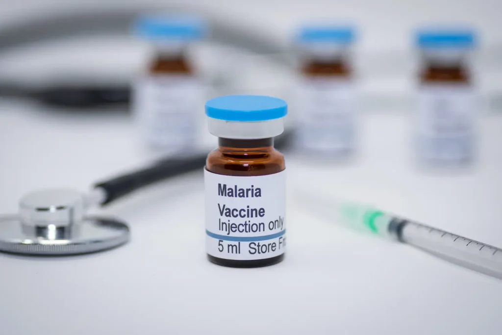 Malaria vaccine vial with syringe and stethoscope