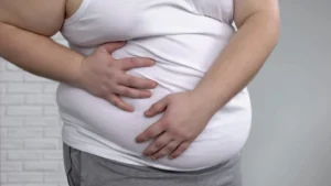 Fat male suffering internal organs pain, metabolic disorder, liver inflammation