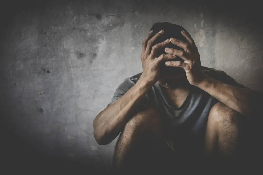 Men who show stress and loneliness, Homeless man drug  addict sitting alone and depressed  at an abandoned house feeling anxious and lonely, social documentary concept, Copy space