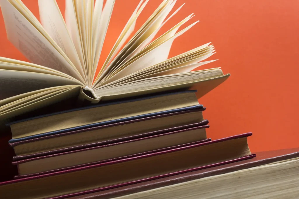 Open book, hardback books on wooden table. Back to school. Copy space.