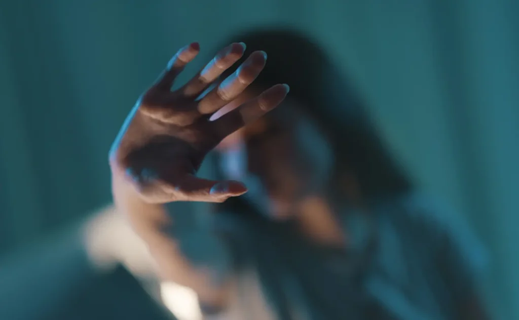 Woman doing a stop sign with her hand, women protection concept