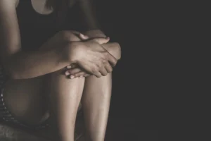 Woman lying on the floor crying with depression