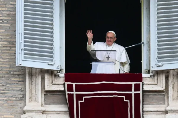 102198930 pope francis waves from the window of the apostolic palace during the weekly angelus praye