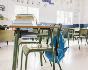 school classroom with books backpack
